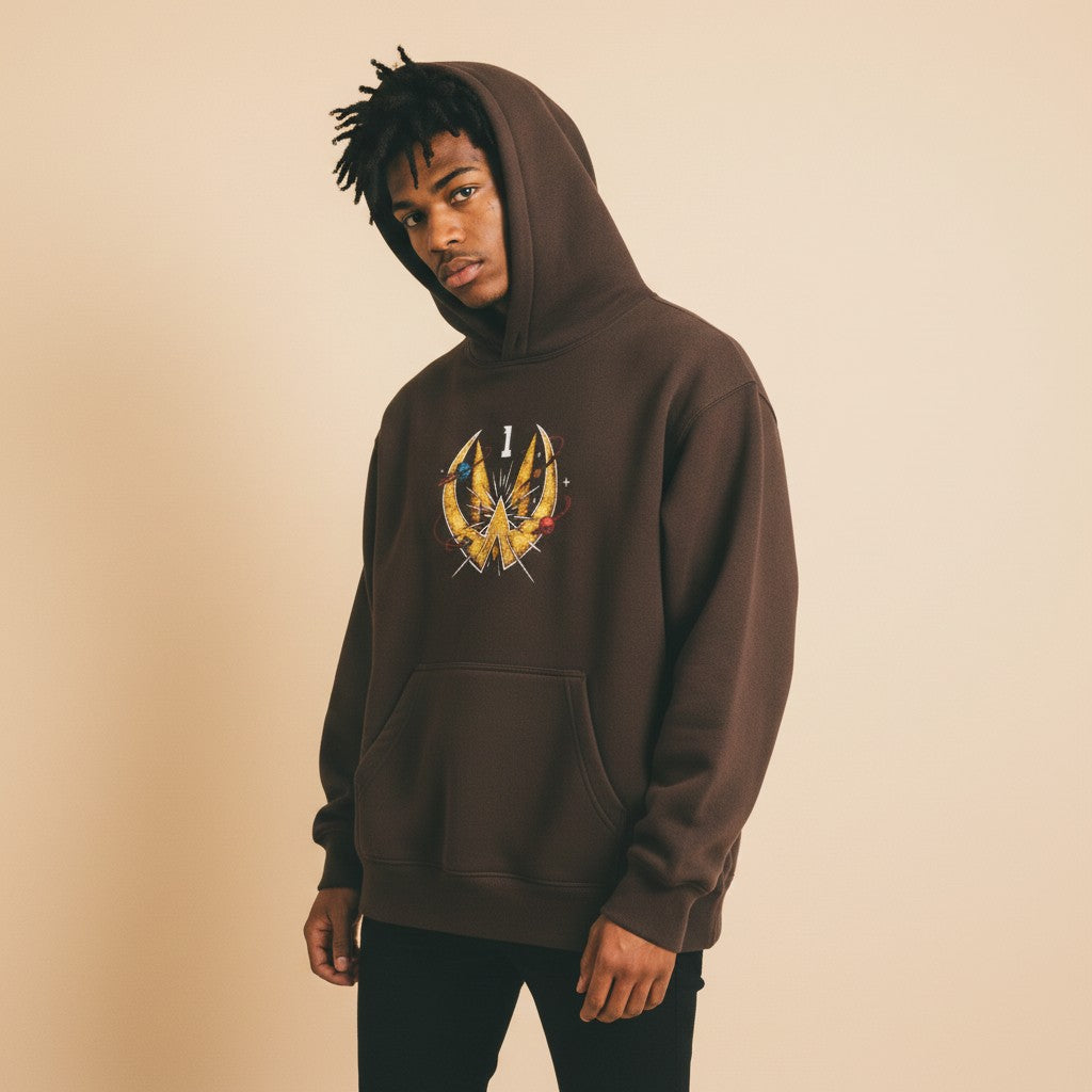 Athlete Xclusive brown heavyweight hoodie with a gold comic book graphic featuring the number 1 and celestial elements.